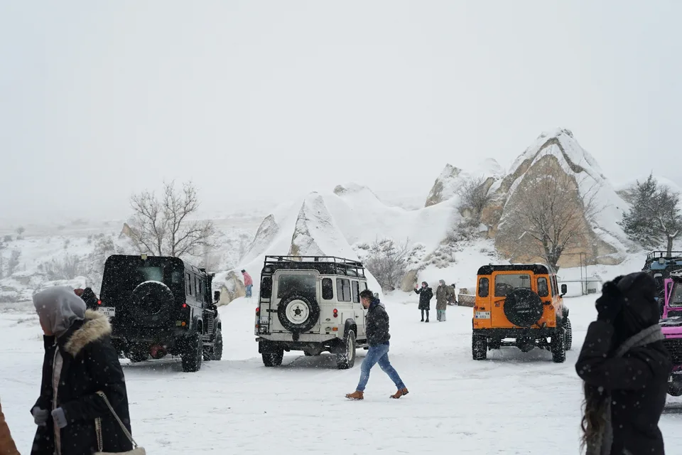 Karlı Kapadokya vadisinde jeep safari araçları