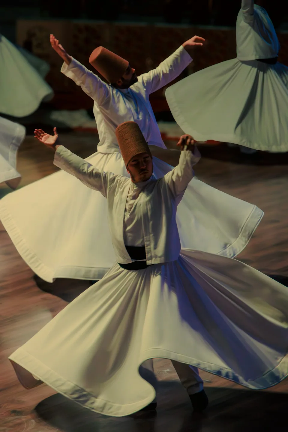 Whirling dervishes spinning in white robes