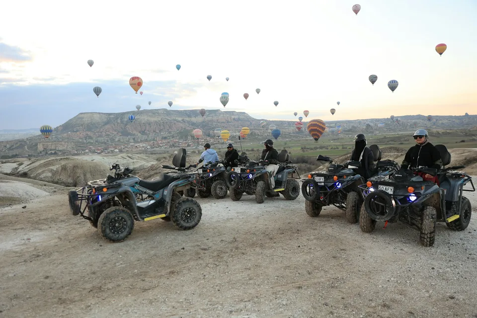 ATV tour beneath hot air balloons in Cappadocia