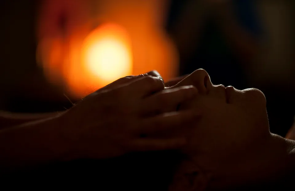 Face and head massage in soft light