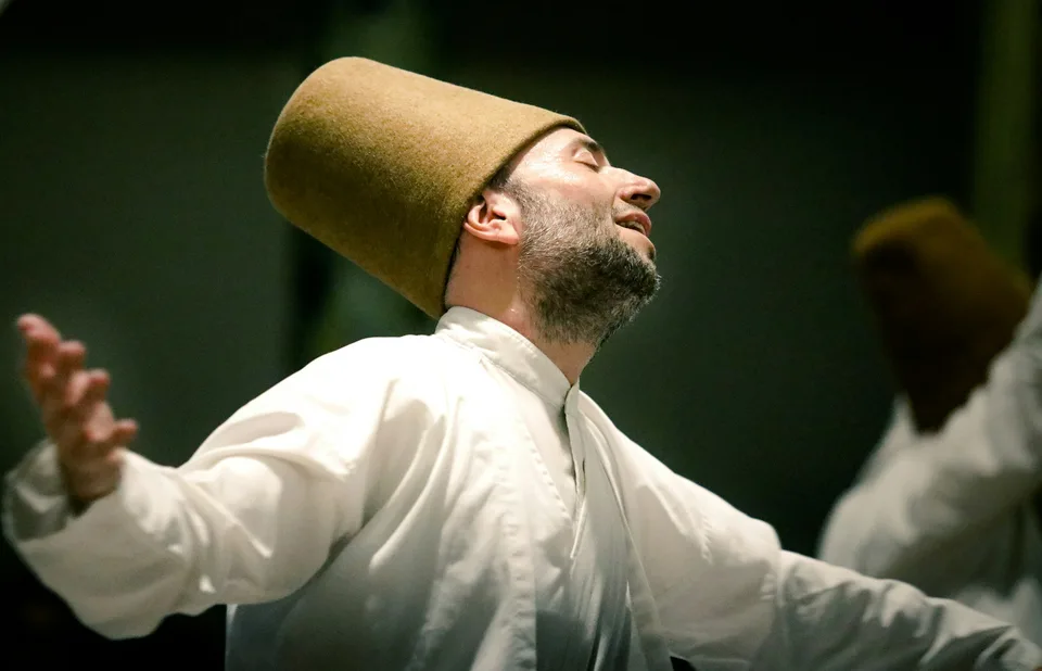 A whirling dervish turning with eyes closed during the sema